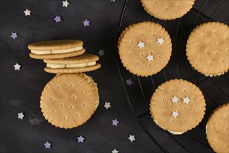 Cream filled sandwich cookies on dark background