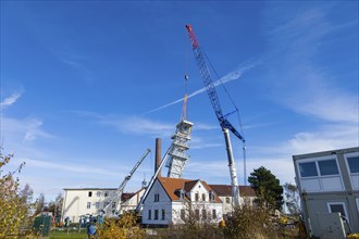 After its restoration, the 34-metre-high winding tower of the rich mine has been lifted back into