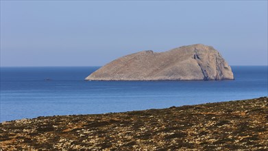 Large rocky island in the calm blue sea, natural and peaceful scene, view of Pontikonisi islet,