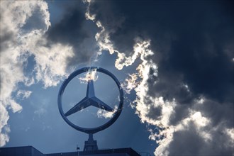 Symbolic image, Dark clouds at Mercedes, Mercedes logo on a building surrounded by dramatic cloud