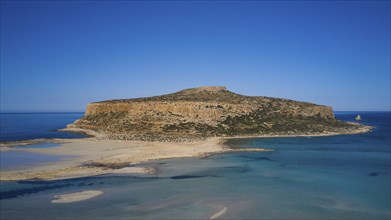 Aerial view of a rocky island with shallow coastline and blue water, Gramvoussa, Gramvoussa