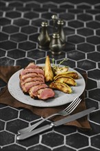 Sliced duck breast cooked to a perfect medium-rare served with caramelised apples and pears on a