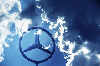 Symbolic image, Dark clouds at Mercedes, Mercedes logo on a building surrounded by dramatic cloud