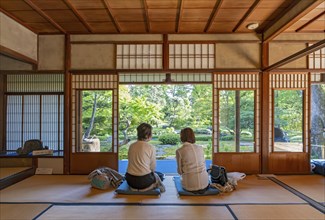 Two women enjoy tea inside the Old Mitsui Family Shimogamo Villa, Kyoto