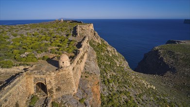 Drone shot, A historic fortress ruin running along a cliff and looking down to the sea, Venetian