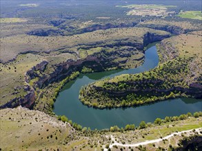 Expansive view of a river winding through deep gorges and hilly landscape, aerial view, gorge,