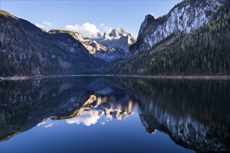 The Vordere Gosausee lake in autumn with a view of the Dachstein mountain range. The Gosaukamm on