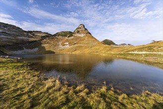 Lake Augstsee and the Atterkogel mountain on the Loser. Autumn, good weather, blue sky. Reflection.