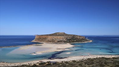 Large island surrounded by a clear blue sea under an unclouded sky, natural beauty, Gramvoussa,