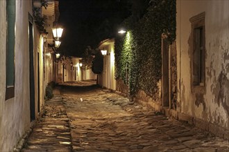 Atmospheric night view of illuminated street and buildings in historical center of Paraty, Brazil,