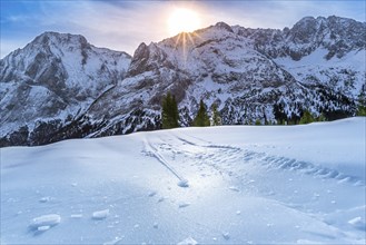 Alpine scenery on a bright day of winter, with details over the crust of ice, that lies on the