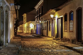 Atmospheric night view of illuminated street and buildings in historical center of Paraty, Brazil,