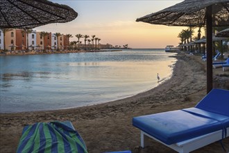 View of a lagoon of the Red Sea at sunrise between two rows of hotel room in Hurghada