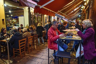 People eating and drinking on the street in Bologna, Italy, Europe