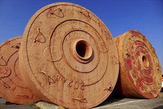 Large vintage mooring buoys are stored on dry land