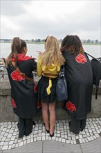 Three costumed woman looking at the Rhine, back view, cosplay at Japan Day Düsseldorf, North