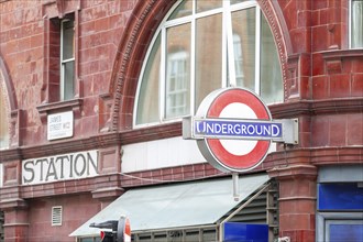 Entrance area of a London Underground station with red brick, London, United Kingdom Great Britain