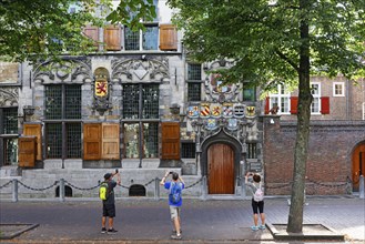 Historic city centre of Delft, tourists photograph Gemeenlandshuis van Delfland, town hall, oldest