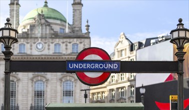 London Underground sign in front of a historic building on a sunny day, London, United Kingdom