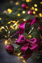 Christmas garland with gold and magenta ribbons intertwined with pine needles and tiny twinkling