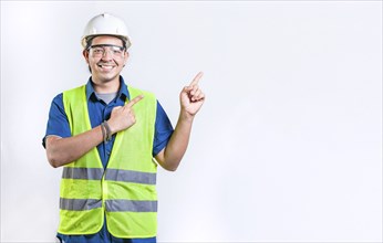 Happy male engineer pointing to side isolated. Smiling male engineer pointing blank space isolated