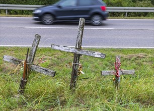 Cross on a country road, symbol of remembrance for three road accident victims. Laichigen,