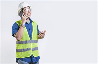 Civil engineer talking phone isolated. Young latin engineer calling on cell phone isolated