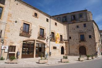 Old stone buildings along a quiet city street under a clear sky, former prison, museum, Sepúlveda,