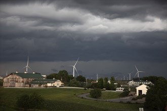 Adair, Iowa, A storm approaches a farm and wind turbines in western Iowa