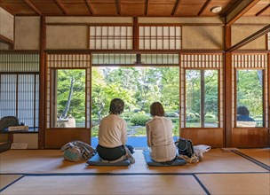 Two women enjoy tea inside the Old Mitsui Family Shimogamo Villa, Kyoto