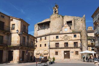 Building and an old church with a bell tower on a sunny town square, Castillo, old castle fortress,