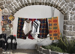 Souvenir sale in the spa town of Monchique, Algarve, Portugal, Traditional colourful textiles hang