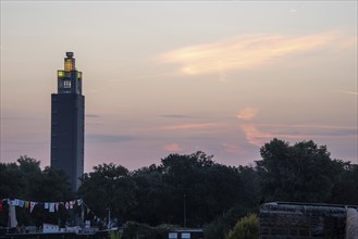 Illuminated Albin Mueller Tower in Rotehorn City Park shortly in front of sunrise, Magdeburg,