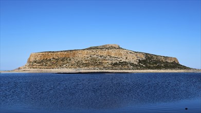 Large rocky island in the calm blue sea under a clear sky, Gramvoussa, Gramvoussa peninsula, Pirate