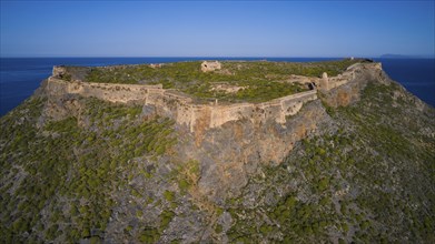 Drone shot, Historic fortress on rocky cliffs under a clear sky, Venetian sea fortress, Gramvoussa,