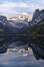 The Vordere Gosausee lake in autumn with a view of the Dachstein mountain range. The Gosaukamm on