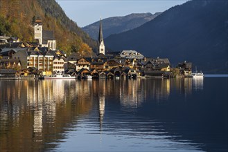 View of Hallstatt and Lake Hallstatt. In the morning in autumn. Good weather, blue sky. Reflection.