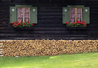 Log cabin with flower boxes, geraniums, shutters, stock of firewood, logs, romantic, Vigiljoch,