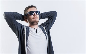 Handsome guy in sunglasses relaxed with hands behind his head, Vacation concept