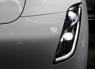 Volkswagen logo reflected in a Tesla Semi truck at the IAA Transportation trade fair, Hanover,