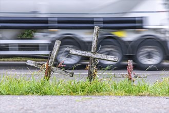 Cross on a country road, symbol of remembrance for three road accident victims. Laichigen,