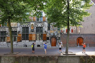 Historic city centre of Delft, tourists photograph Gemeenlandshuis van Delfland, town hall, oldest