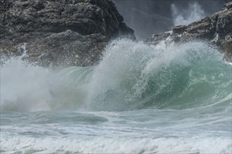 Large waves of the Atlantic Ocean crash against the rocks of a cliff. Camaret sur mer, Crozon,