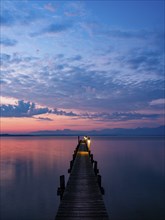 Footbridge on Lake Chiemsee at dawn, with the Chiemgau Alps behind, Chiemgau, Upper Bavaria,