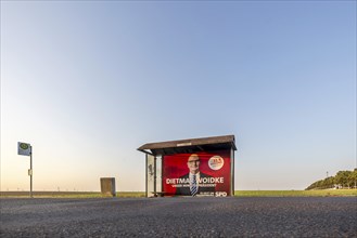 State election in Brandenburg. Bus shelter in an open field with an election poster of Prime