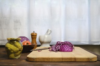 Red cabbage and ingredients for salad on kitchen table