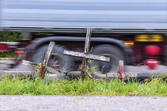 Cross on a country road, symbol of remembrance for three road accident victims. Laichigen,