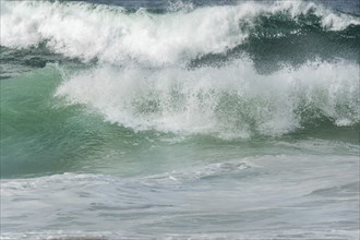 Turquoise blue wave in the Iroise Sea. Camaret, Crozon, Brittany, France, Europe