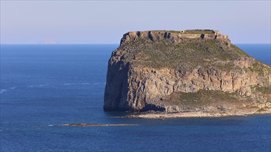 Close-up of an island with steep cliffs in the blue sea, Venetian Sea Fortress, Gramvoussa,