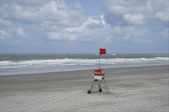 Empty sandy beach on the North Sea coast, DLRG red flag, bathing and swimming prohibited,